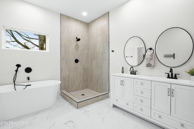 full bath with marble finish floor, double vanity, a freestanding bath, a sink, and a tile shower