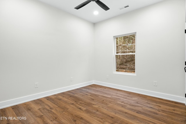 empty room with baseboards, visible vents, dark wood finished floors, a ceiling fan, and recessed lighting