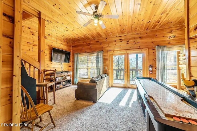 game room with ceiling fan, carpet, wood ceiling, and wooden walls