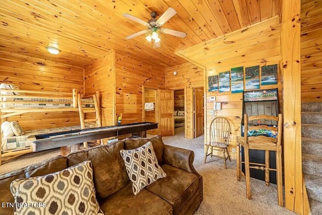 interior space featuring wood ceiling, ceiling fan, wooden walls, and stairs