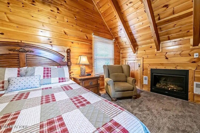 bedroom with visible vents, a glass covered fireplace, lofted ceiling with beams, wooden ceiling, and wood walls