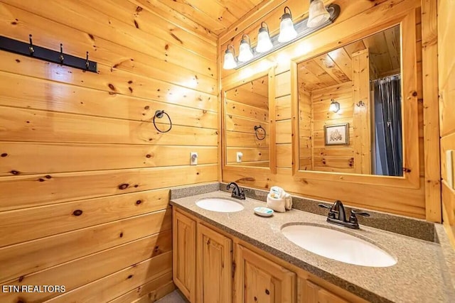 full bath with double vanity, a sink, and wooden walls