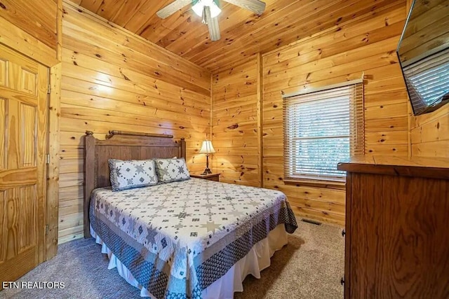 carpeted bedroom featuring wooden ceiling, wood walls, and ceiling fan