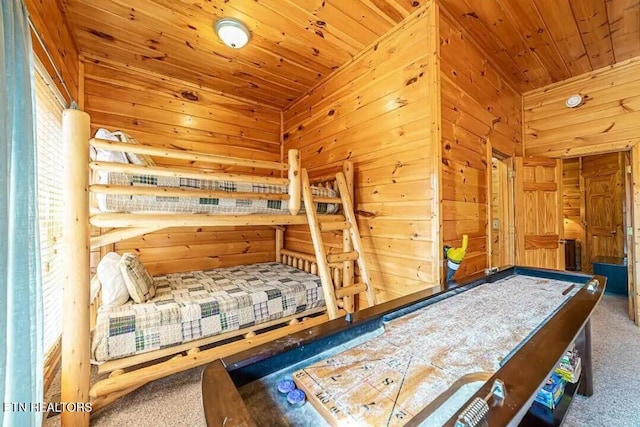 unfurnished bedroom with carpet, wooden ceiling, and wood walls