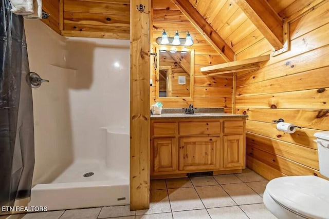 bathroom featuring toilet, a stall shower, tile patterned flooring, and wood walls