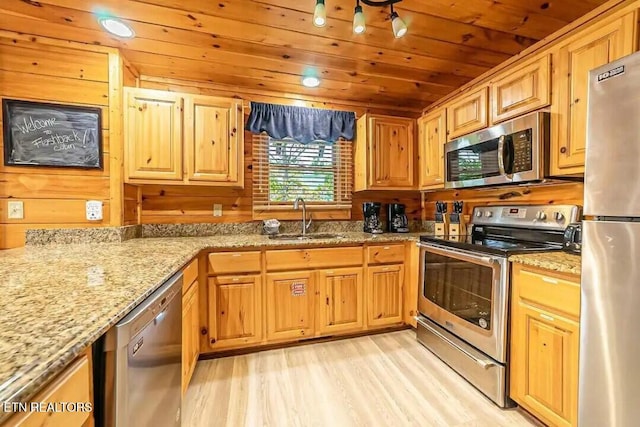 kitchen with light stone counters, a sink, wood ceiling, appliances with stainless steel finishes, and light wood-type flooring