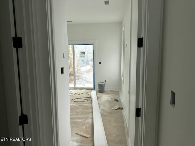 hallway featuring unfinished concrete floors