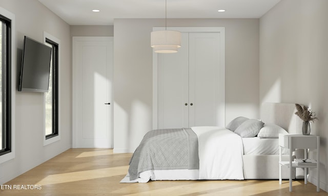 bedroom featuring baseboards, wood finished floors, and recessed lighting