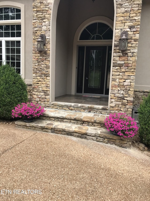 view of exterior entry featuring stone siding