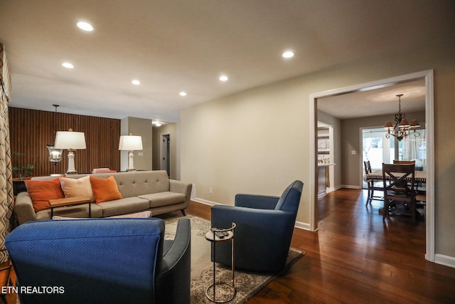 living area featuring dark wood-type flooring, recessed lighting, and an inviting chandelier