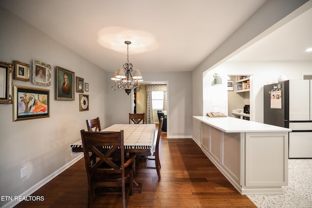 dining area with an inviting chandelier, baseboards, and dark wood finished floors