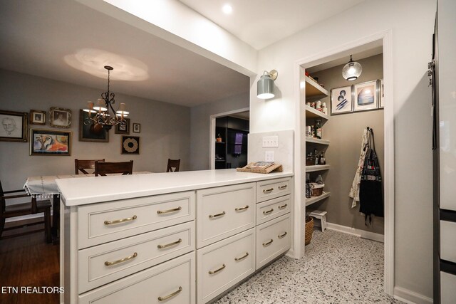 walk in closet with an inviting chandelier