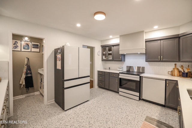 kitchen featuring recessed lighting, white appliances, baseboards, light countertops, and custom range hood