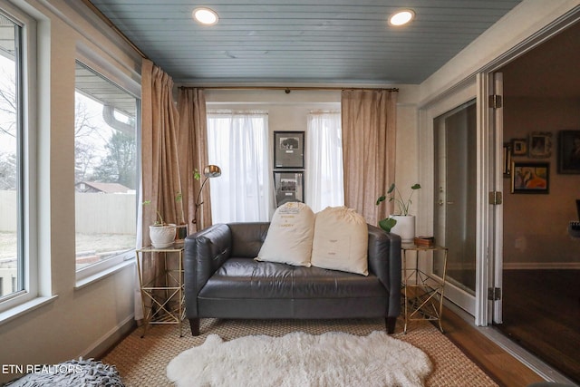 living area featuring recessed lighting, baseboards, and wood finished floors