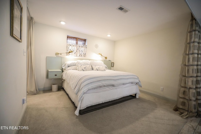 bedroom with recessed lighting, visible vents, light carpet, and baseboards