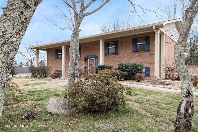 split foyer home featuring brick siding