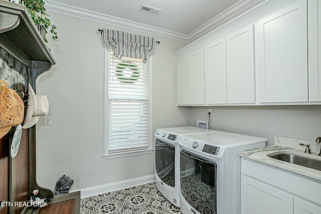 washroom featuring a sink, visible vents, ornamental molding, independent washer and dryer, and cabinet space