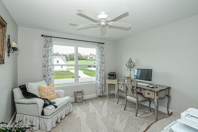 carpeted home office with a ceiling fan, visible vents, and baseboards