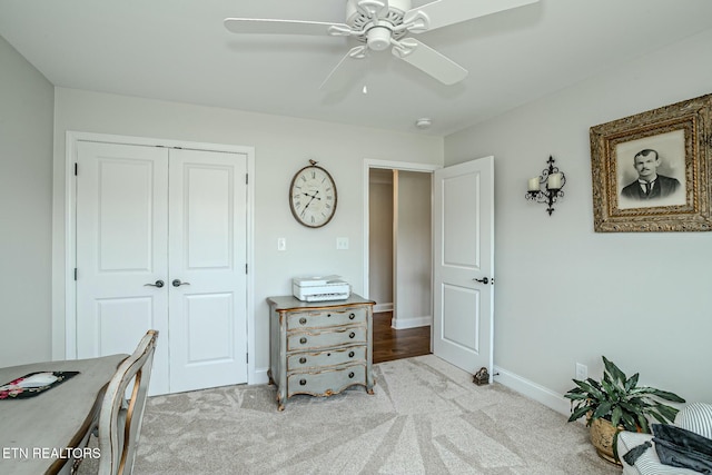 office area with carpet, ceiling fan, and baseboards