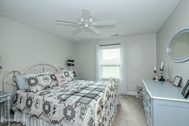 bedroom featuring a ceiling fan, light carpet, visible vents, and baseboards