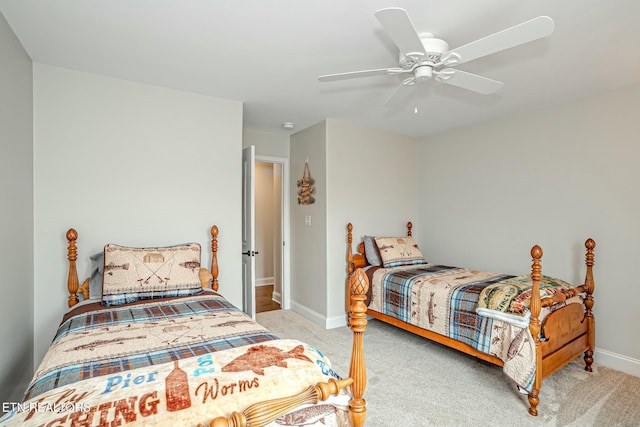 carpeted bedroom with a ceiling fan and baseboards