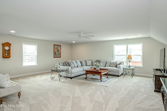 living room with light carpet, baseboards, and a healthy amount of sunlight