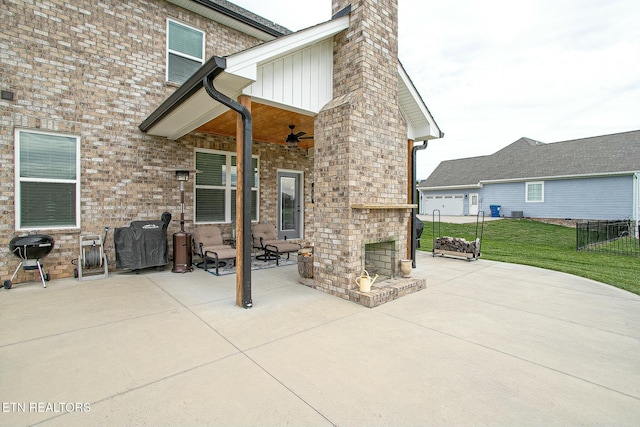 view of patio featuring an outdoor brick fireplace, fence, and a ceiling fan