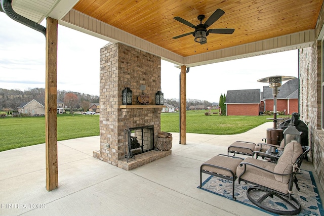 view of patio featuring an outdoor brick fireplace and a ceiling fan