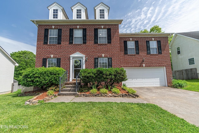 4404 Aylesbury Dr, Knoxville, TN 37918 - colonial house featuring a garage, concrete driveway, and brick siding
