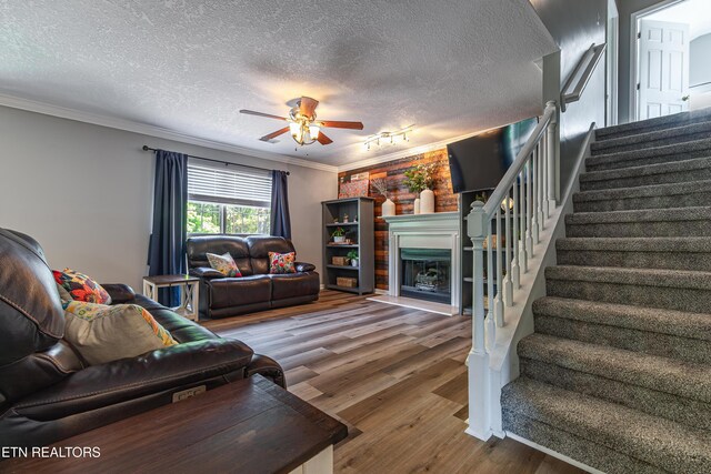 4404 Aylesbury Dr, Knoxville, TN 37918 - living area with stairway, wood finished floors, a textured ceiling, a fireplace with raised hearth, and ceiling fan