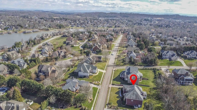 birds eye view of property with a water view and a residential view