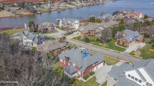 bird's eye view featuring a residential view and a water view