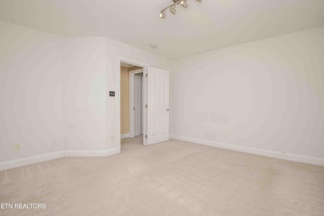 carpeted spare room with baseboards