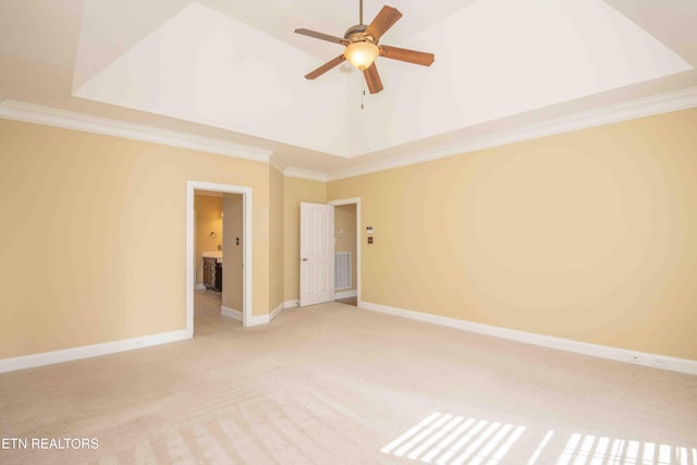 spare room with light colored carpet, visible vents, ornamental molding, ceiling fan, and baseboards