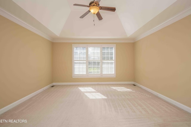 spare room with lofted ceiling, ceiling fan, baseboards, and light colored carpet