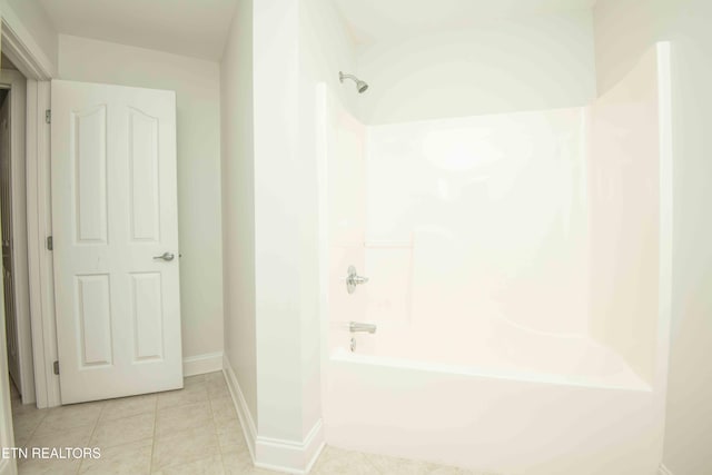 full bath featuring baseboards, tub / shower combination, and tile patterned floors