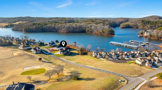 bird's eye view featuring a water view, a residential view, and a wooded view