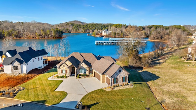 bird's eye view with a water view and a wooded view