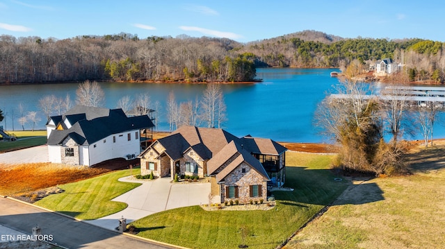 drone / aerial view featuring a water view and a view of trees