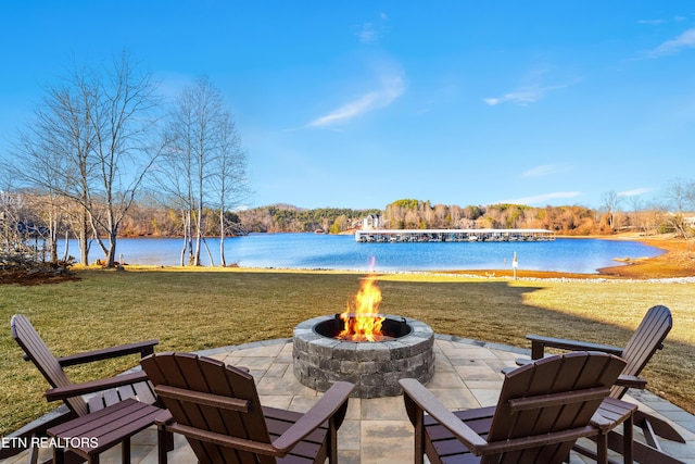 view of patio featuring an outdoor fire pit and a water view