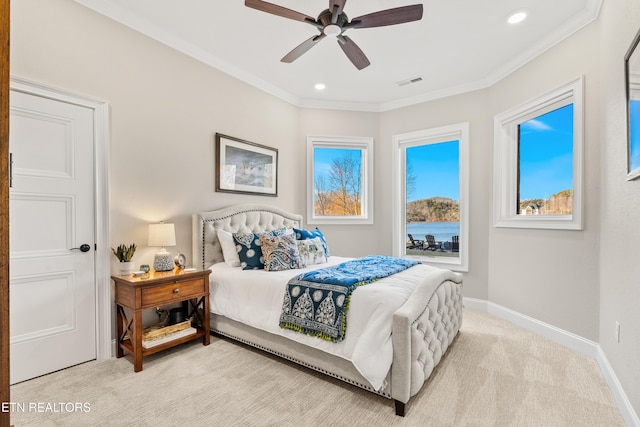 bedroom featuring light colored carpet, a ceiling fan, baseboards, visible vents, and crown molding