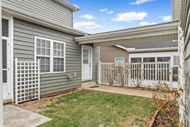 entrance to property featuring a yard