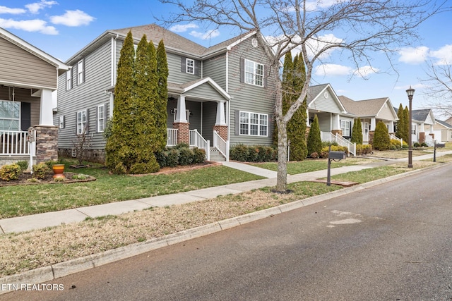 view of front of property with brick siding, a front yard, and a residential view