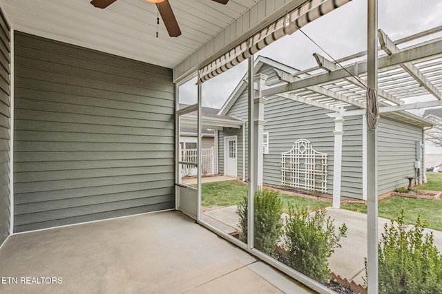 unfurnished sunroom featuring ceiling fan