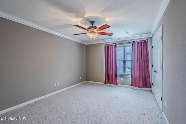 unfurnished room with carpet, ornamental molding, and baseboards