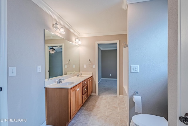 full bath featuring toilet, crown molding, a sink, and tile patterned floors