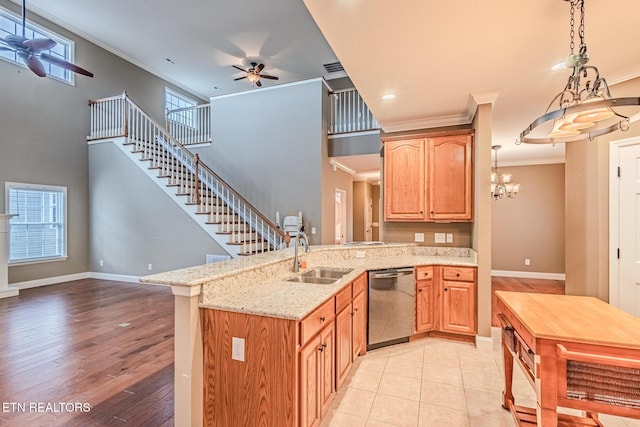 kitchen with ornamental molding, a sink, dishwasher, a peninsula, and ceiling fan with notable chandelier