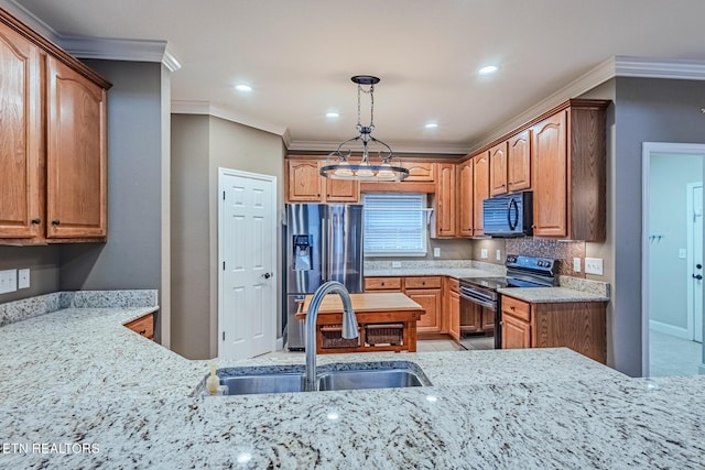 kitchen with light stone countertops, black appliances, ornamental molding, and a sink