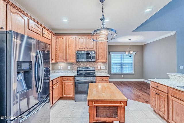 kitchen featuring appliances with stainless steel finishes, light tile patterned flooring, ornamental molding, and light stone countertops