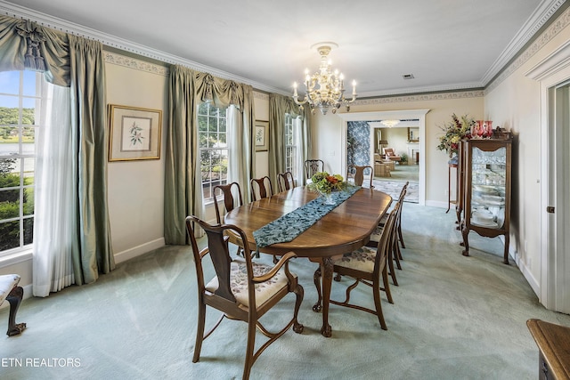 dining room with a notable chandelier, ornamental molding, baseboards, and light carpet